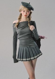 Woman with blonde pigtails and a beret wearing a pleated skirt and off-shoulder top