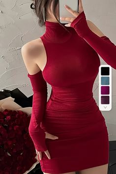 Woman in a red high-neck dress with exposed shoulders holding a phone