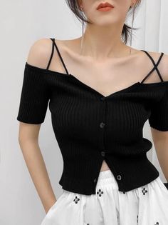 Woman in a black off-shoulder top and white skirt with long earrings