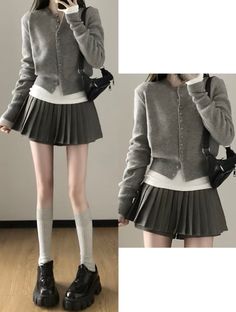 Person in a gray cardigan and pleated skirt with knee-high socks and platform shoes