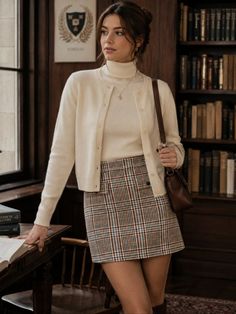 Woman in a plaid skirt and turtleneck sweater in a library