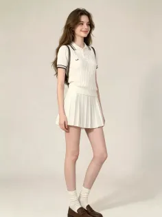 Woman in a white polo shirt and pleated skirt with long brown hair