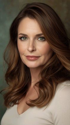 Woman with long brown hair and green eyes in a portrait shot