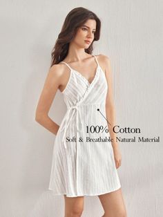 Woman in a white striped wrap dress with spaghetti straps indoors