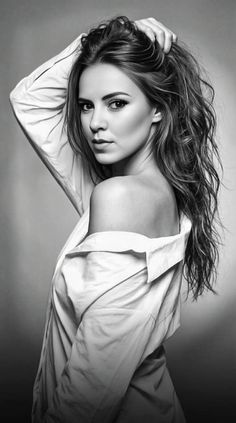 Woman with long hair in an off-shoulder shirt, looking over her shoulder