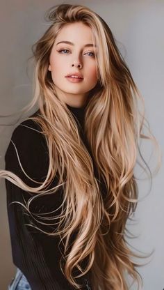 Woman with long blonde hair wearing a black top, looking at the camera
