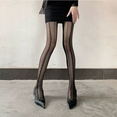 Person in a black mini skirt and sheer stockings with high heels