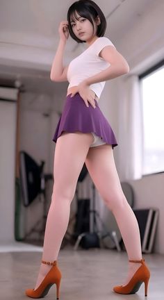 Woman in a white crop top and purple skirt posing indoors