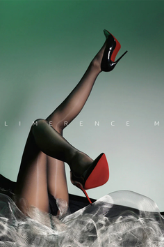 Woman's legs in stockings and high heels against a green background