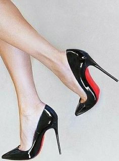 Woman's legs wearing black high heels with red soles