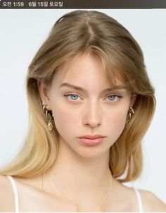 Young woman with blonde hair and blue eyes wearing jewelry
