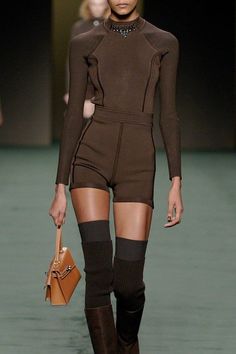 Model in a brown outfit with shorts, long sleeve top, and knee-high socks