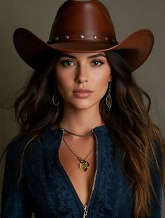 Woman in a cowboy hat and blue jacket with an open zipper