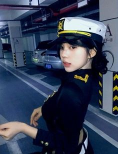 Woman in a sailor uniform posing in an underground parking garage