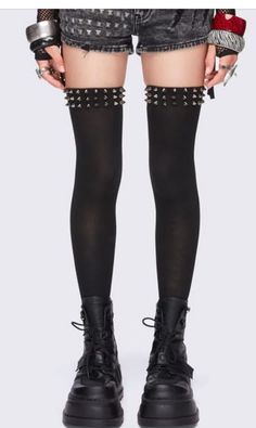 Person wearing black thigh highs with studs, denim shorts, and platform boots