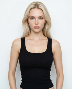 Blonde woman in a black tank top against a white background