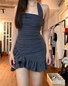 Woman in a striped halter dress with a ruffle skirt indoors