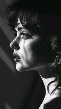 Black and white profile portrait with dramatic lighting and shadows