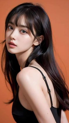 Woman with long black hair wearing a black top against an orange background