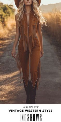 Woman in a cowboy hat and fringe outfit walking outdoors at golden hour