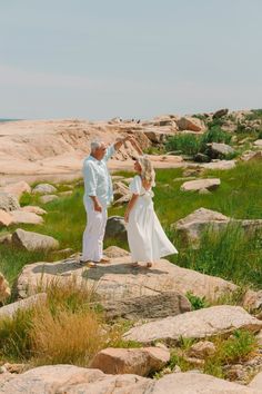 Couple dancing on rocks in a sunny outdoor landscape