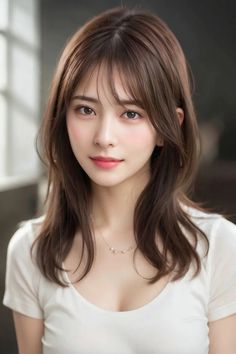 Woman with long brown hair wearing a white shirt and necklace