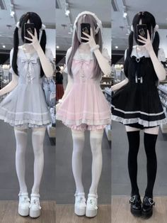 Three people in different colored lolita dresses and thigh-high socks