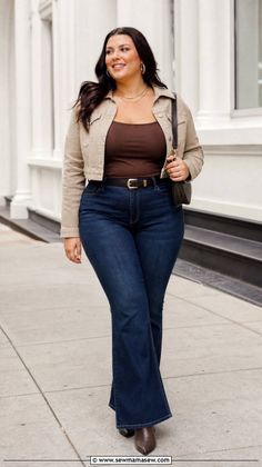 Woman with long dark hair wearing a denim jacket and flared jeans on a street
