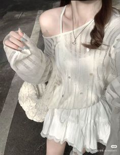 Person in a white off-shoulder top and mini skirt with lace trim
