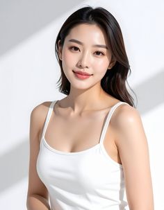 Woman in a white tank top with soft lighting and shadows on a white background