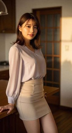 Woman with long hair wearing a blouse and mini skirt indoors