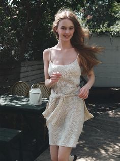 Woman in a polka dot summer dress with long hair outdoors