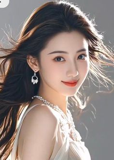 Woman with long hair and jewelry in a portrait with soft lighting
