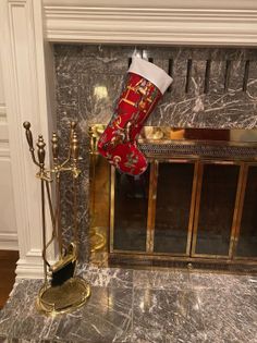 Christmas stocking with a cowboy print hanging on a marble fireplace