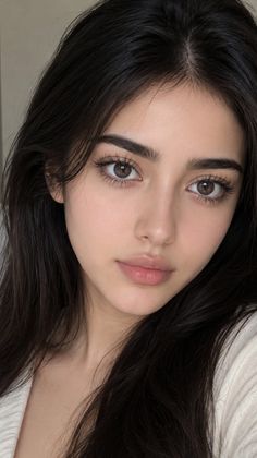 Close up portrait of a woman with long dark hair and brown eyes