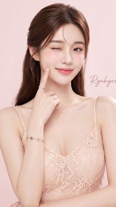Woman with long hair winking and wearing a lace top and jewelry