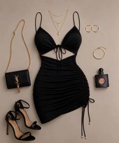 Black mini dress with cut-outs and ruched details, paired with accessories