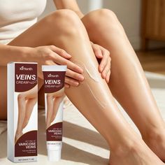 Person applying cream to their bare leg, with product packaging visible
