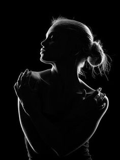 Woman in silhouette with backlight and hair bun