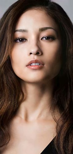 Close up portrait of a woman with long brown hair and soft lighting