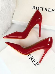 Pair of shiny red patent leather high heels with pointed toes