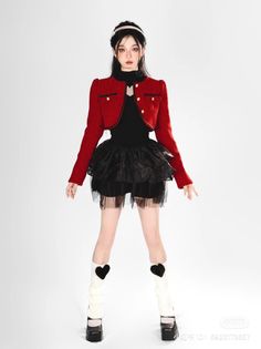 Woman in a red jacket and black tutu skirt with white leg warmers and platform shoes