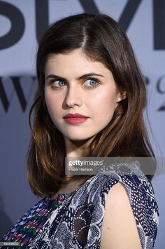 Woman with blue eyes and brown hair wearing a patterned dress