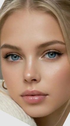 Close up portrait of a woman with blonde hair and blue eyes