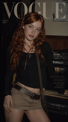 Woman with red hair wearing a mini skirt and cropped top indoors