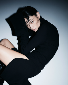 Woman in a black dress with wet hair and dramatic lighting