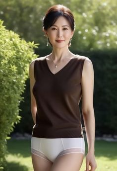 Woman in a brown sleeveless top and white underwear in a garden