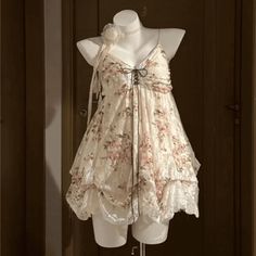 Lace floral dress with ruffles and a choker on a mannequin