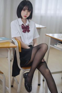 Girl in a school uniform sitting in a classroom