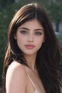 Woman with long dark hair and blue eyes in a portrait shot outdoors